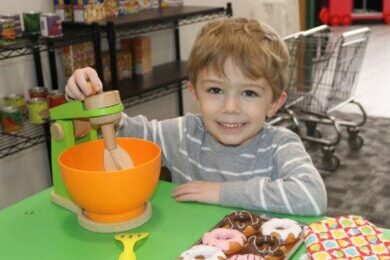 Boy playing with kitchen toys