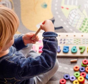 Young child learning with hands-on toys