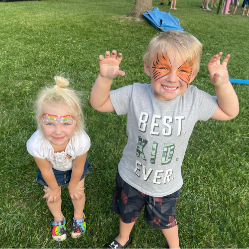 Boy and girl with face paint at family night out